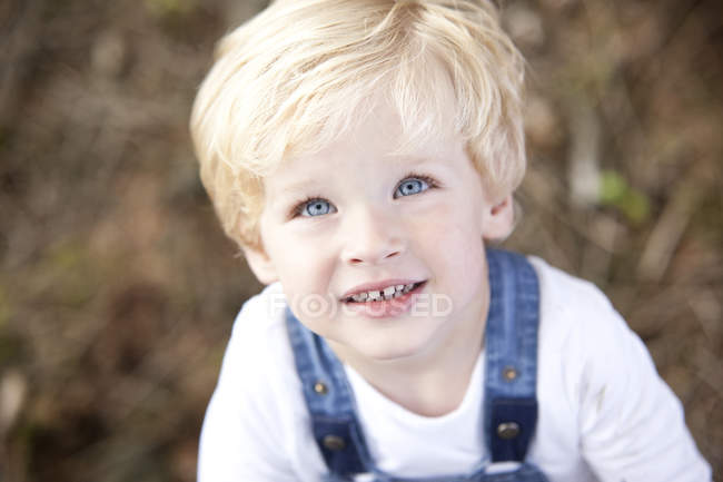 focused_179048752-stock-photo-portrait-smiling-little-boy-blue